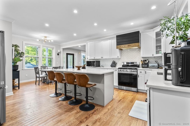 308 Old Zoar Rd, Monroe, CT 06468 - kitchen with stainless steel appliances, crown molding, a kitchen breakfast bar, light countertops, and white cabinets