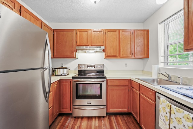 745 Merrow Rd Apt 171, Coventry, CT 06238 - kitchen featuring appliances with stainless steel finishes, under cabinet range hood, a sink, light countertops, and a textured ceiling
