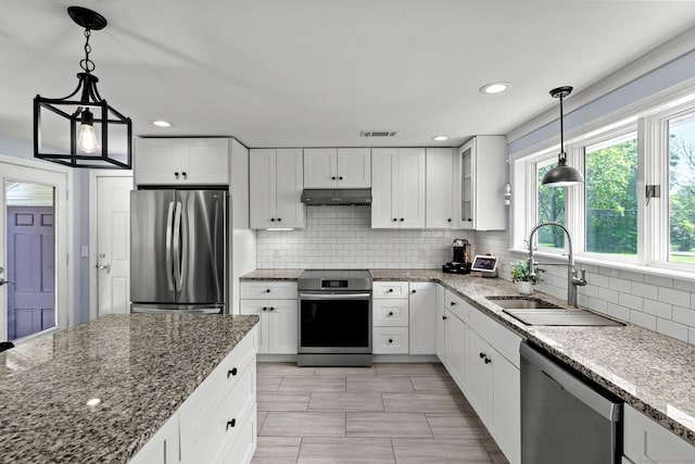 401 Russell Ave, Suffield, CT 06078 - kitchen featuring appliances with stainless steel finishes, a sink, under cabinet range hood, white cabinetry, and recessed lighting