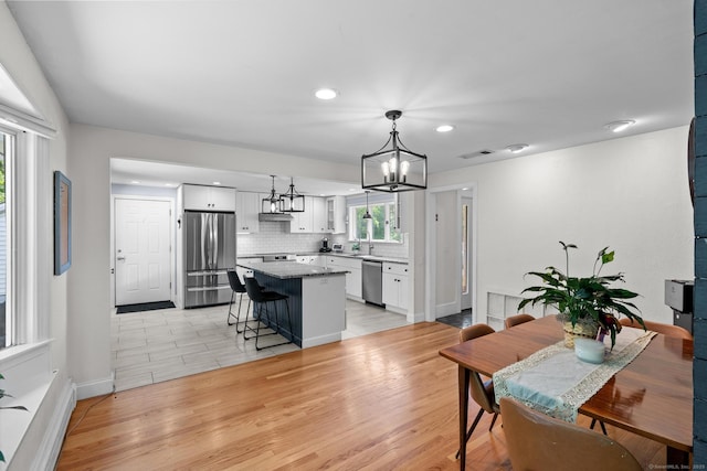 401 Russell Ave, Suffield, CT 06078 - dining space featuring a chandelier, recessed lighting, light wood-style flooring, and baseboards
