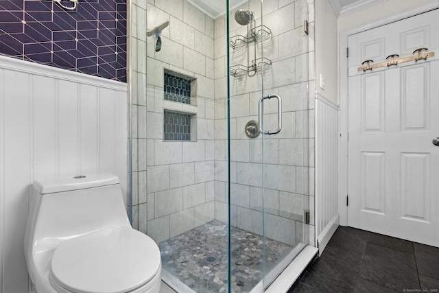 401 Russell Ave, Suffield, CT 06078 - bathroom featuring ornamental molding, a stall shower, toilet, wainscoting, and a decorative wall