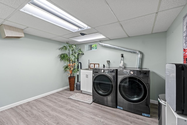 401 Russell Ave, Suffield, CT 06078 - laundry area with washer and dryer, cabinet space, light wood-type flooring, and baseboards