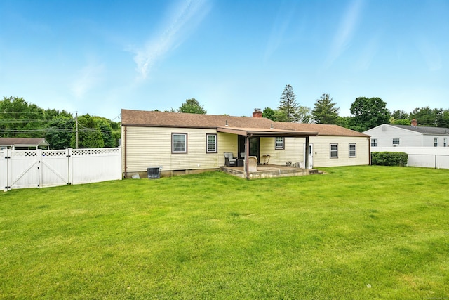 47 Varno Ln, Enfield, CT 06082 - back of house featuring a patio, a gate, a chimney, and central AC unit