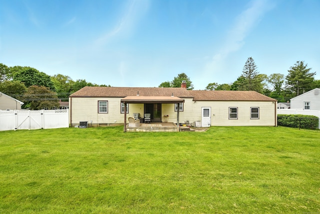 47 Varno Ln, Enfield, CT 06082 - rear view of house with a patio, a gate, and a chimney