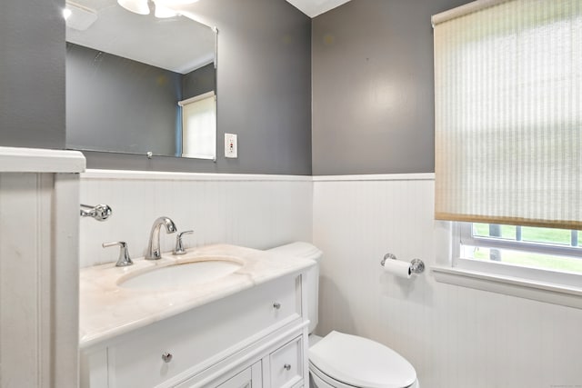 47 Varno Ln, Enfield, CT 06082 - half bathroom featuring toilet, a wainscoted wall, and vanity