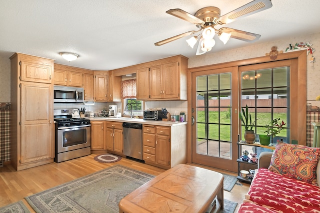 47 Varno Ln, Enfield, CT 06082 - kitchen with stainless steel appliances, light wood-type flooring, light countertops, ceiling fan, and a sink