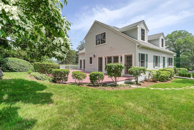 50 Harrison Ave, New Canaan, CT 06840 - back of house featuring a lawn and roof with shingles