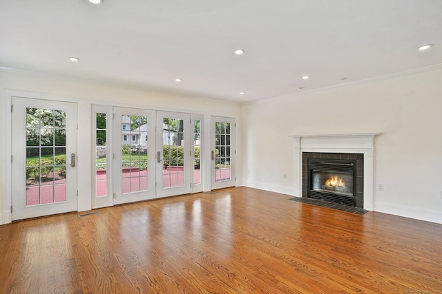 50 Harrison Ave, New Canaan, CT 06840 - unfurnished living room featuring a fireplace, french doors, healthy amount of natural light, wood finished floors, and recessed lighting