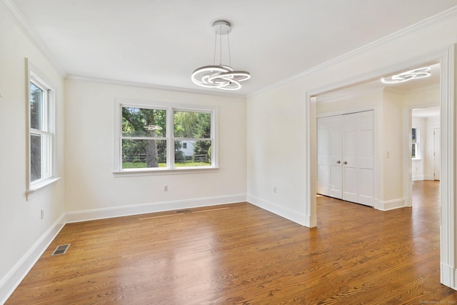50 Harrison Ave, New Canaan, CT 06840 - empty room with a chandelier, ornamental molding, baseboards, and wood finished floors