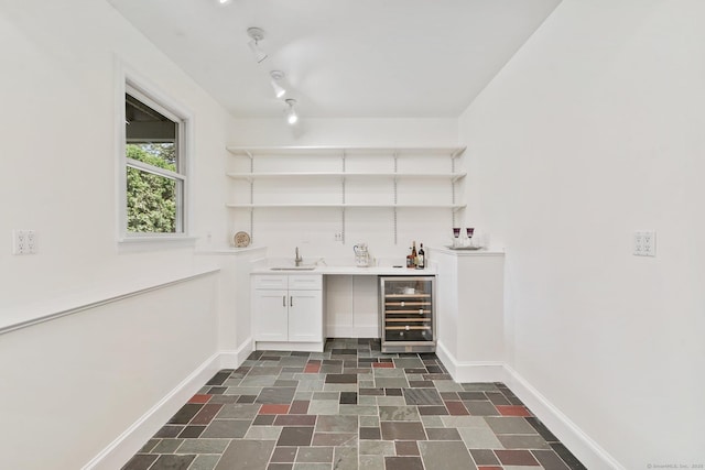 50 Harrison Ave, New Canaan, CT 06840 - indoor wet bar featuring beverage cooler, baseboards, and dark stone finish flooring