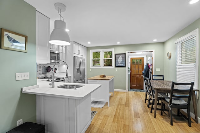 128 Mill River St, New Haven, CT 06511 - kitchen with stainless steel appliances, a kitchen island, backsplash, recessed lighting, and wood counters