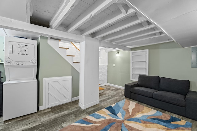 128 Mill River St, New Haven, CT 06511 - living area with wood finished floors, stacked washer and clothes dryer, stairway, beam ceiling, and baseboards