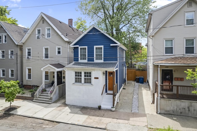 128 Mill River St, New Haven, CT 06511 - view of front facade with entry steps and stucco siding