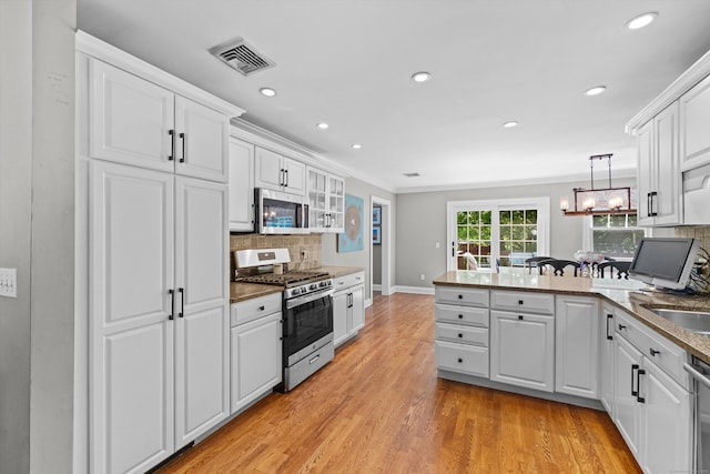40 Thunder Hill Ln, Ridgefield, CT 06877 - kitchen featuring stainless steel appliances, a peninsula, white cabinetry, backsplash, and recessed lighting