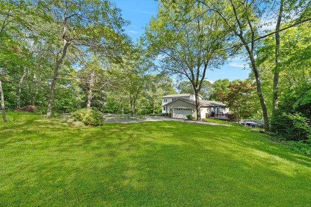 40 Thunder Hill Ln, Ridgefield, CT 06877 - view of grassy yard featuring a garage and driveway