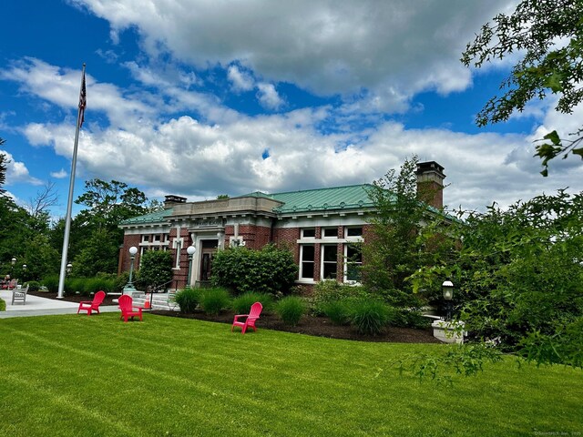 40 Thunder Hill Ln, Ridgefield, CT 06877 - back of house featuring a chimney, brick siding, a yard, and metal roof