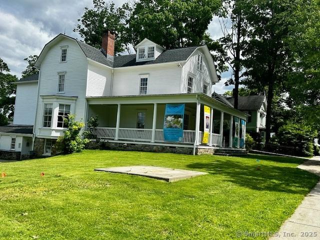40 Thunder Hill Ln, Ridgefield, CT 06877 - view of front facade featuring a porch, a front yard, a chimney, and roof with shingles