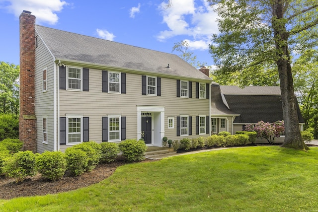 47 Ridgecrest Rd, Stamford, CT 06903 - colonial-style house with a chimney, a front lawn, and a shingled roof