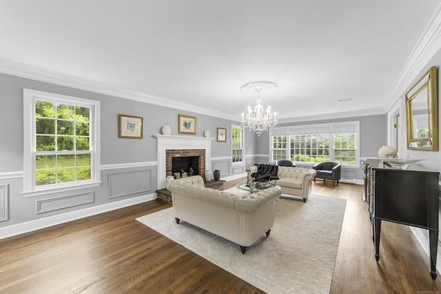 47 Ridgecrest Rd, Stamford, CT 06903 - living area with a chandelier, a fireplace, wood finished floors, ornamental molding, and a wainscoted wall