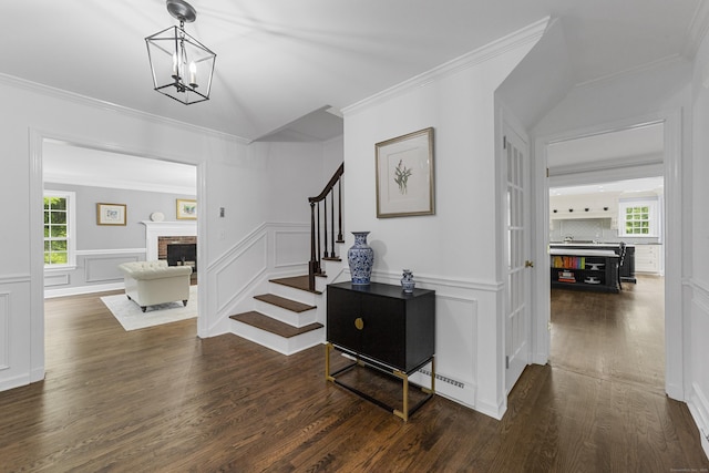 47 Ridgecrest Rd, Stamford, CT 06903 - foyer with stairs, dark wood finished floors, crown molding, a fireplace, and a decorative wall