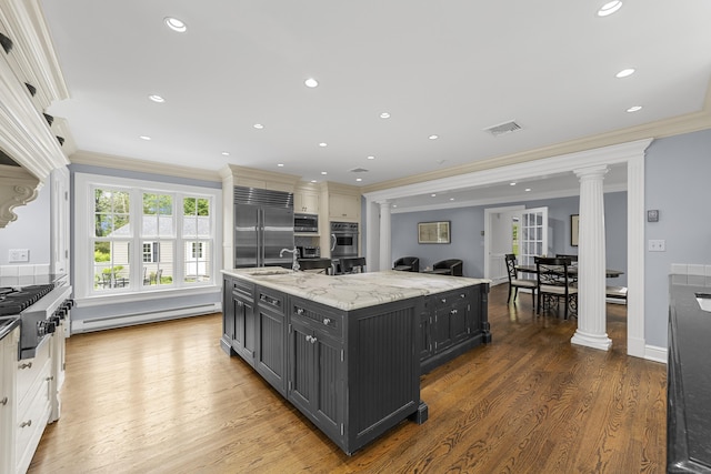 47 Ridgecrest Rd, Stamford, CT 06903 - kitchen featuring ornate columns, crown molding, a sink, a baseboard heating unit, and built in appliances