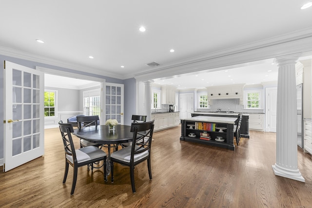 47 Ridgecrest Rd, Stamford, CT 06903 - dining space featuring decorative columns, crown molding, wood finished floors, plenty of natural light, and recessed lighting