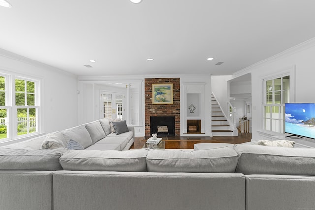 47 Ridgecrest Rd, Stamford, CT 06903 - living room with ornamental molding, wood finished floors, healthy amount of natural light, a fireplace, and stairs