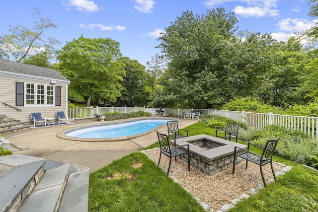 47 Ridgecrest Rd, Stamford, CT 06903 - view of swimming pool with a fire pit, a patio, a fenced backyard, and view of wooded area