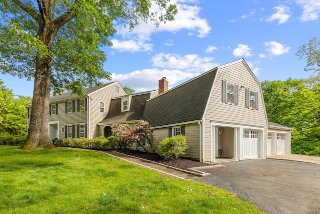47 Ridgecrest Rd, Stamford, CT 06903 - view of front of home featuring driveway, roof with shingles, a gambrel roof, a chimney, and a front lawn