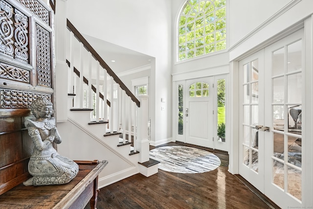 975 Flintlock Rd, Fairfield, CT 06890 - foyer featuring a towering ceiling, wood finished floors, baseboards, stairway, and crown molding