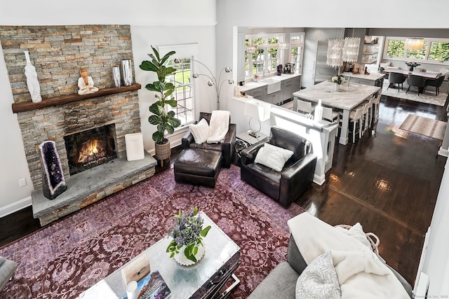 975 Flintlock Rd, Fairfield, CT 06890 - living area featuring wood finished floors, a stone fireplace, and baseboards