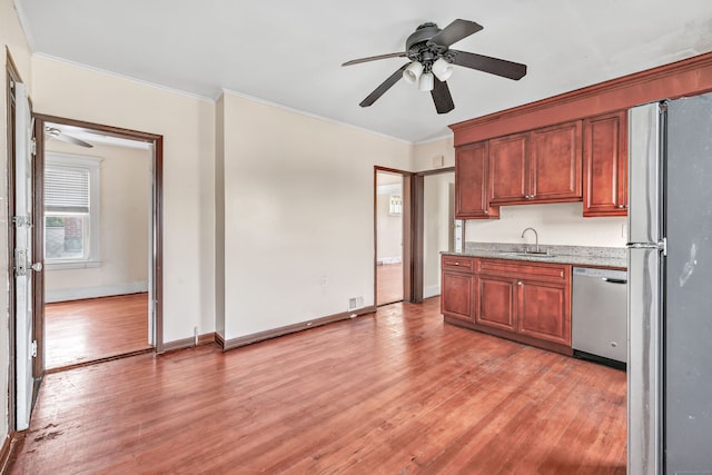 174 Franklin Ave, Stratford, CT 06614 - kitchen with stainless steel appliances, a sink, ceiling fan, crown molding, and light wood-type flooring