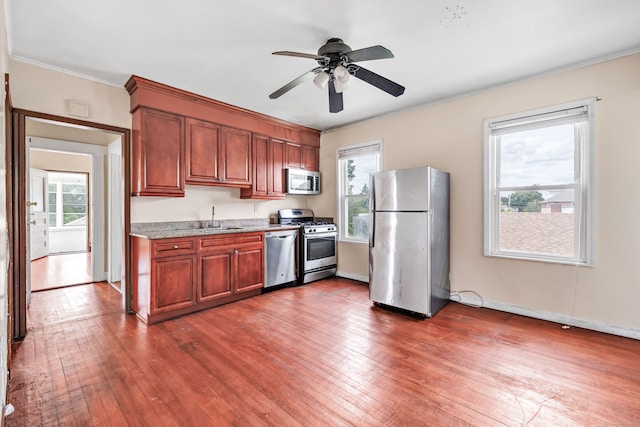 174 Franklin Ave, Stratford, CT 06614 - kitchen featuring stainless steel appliances, hardwood / wood-style floors, a ceiling fan, crown molding, and a sink
