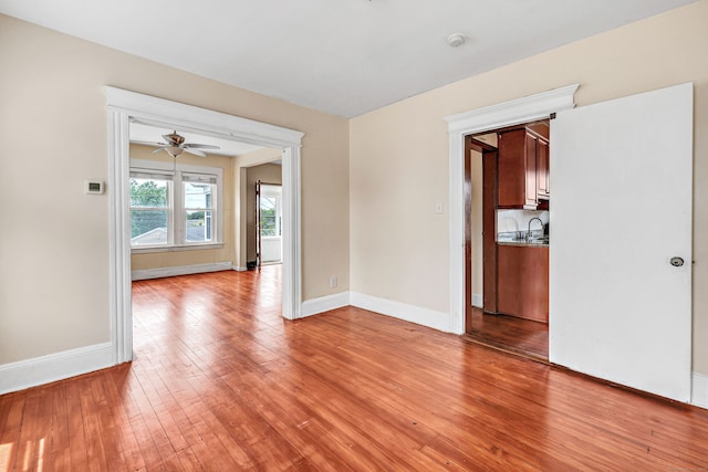 174 Franklin Ave, Stratford, CT 06614 - unfurnished room with light wood-type flooring, a sink, baseboards, a smoke detector, and ceiling fan