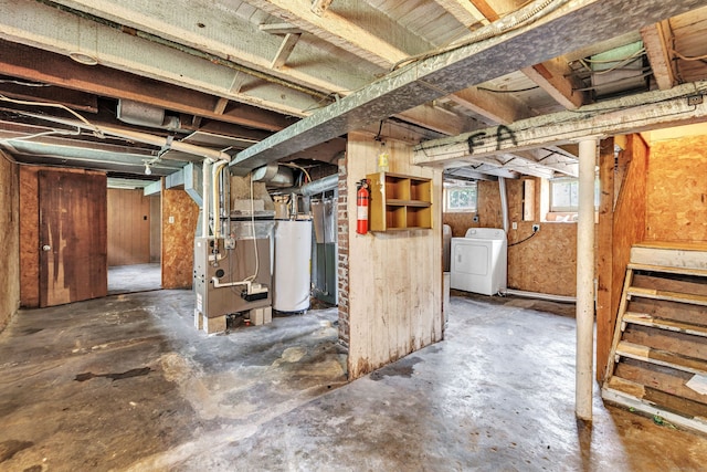 174 Franklin Ave, Stratford, CT 06614 - below grade area featuring water heater, heating unit, and washing machine and clothes dryer