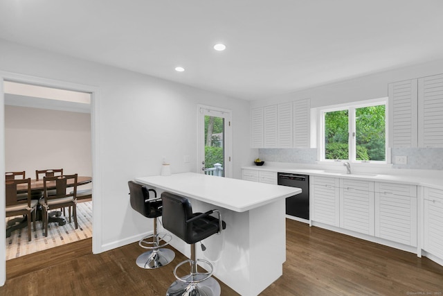 14 The Mews, Westport, CT 06880 - kitchen with black dishwasher, dark wood-style flooring, a breakfast bar area, healthy amount of natural light, and recessed lighting