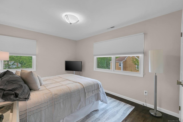 14 The Mews, Westport, CT 06880 - bedroom with baseboards, multiple windows, and dark wood-style flooring