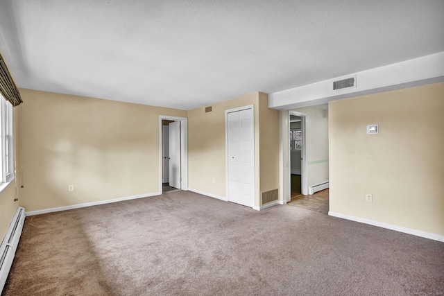 4 Loveland Hill Rd Unit F2, Vernon, CT 06066 - carpeted spare room with a baseboard heating unit, baseboards, and a textured ceiling