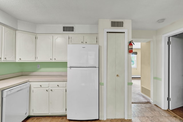 4 Loveland Hill Rd Unit F2, Vernon, CT 06066 - kitchen featuring white appliances, white cabinetry, a baseboard heating unit, light countertops, and light stone finish floors