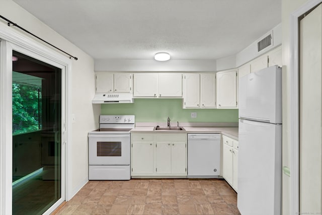 4 Loveland Hill Rd Unit F2, Vernon, CT 06066 - kitchen with white appliances, under cabinet range hood, light countertops, white cabinets, and stone finish floors
