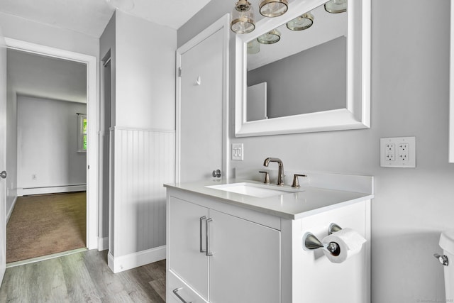 4 Loveland Hill Rd Unit F2, Vernon, CT 06066 - bathroom featuring a baseboard heating unit, vanity, wood finished floors, toilet, and baseboards