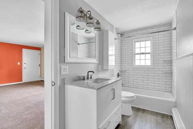4 Loveland Hill Rd Unit F2, Vernon, CT 06066 - bathroom featuring vanity, a textured ceiling, tub / shower combination, toilet, and baseboard heating