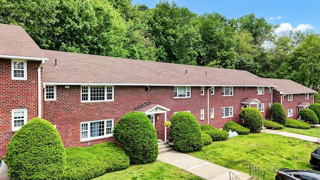 4 Loveland Hill Rd Unit F2, Vernon, CT 06066 - colonial home with roof with shingles, brick siding, and a front lawn