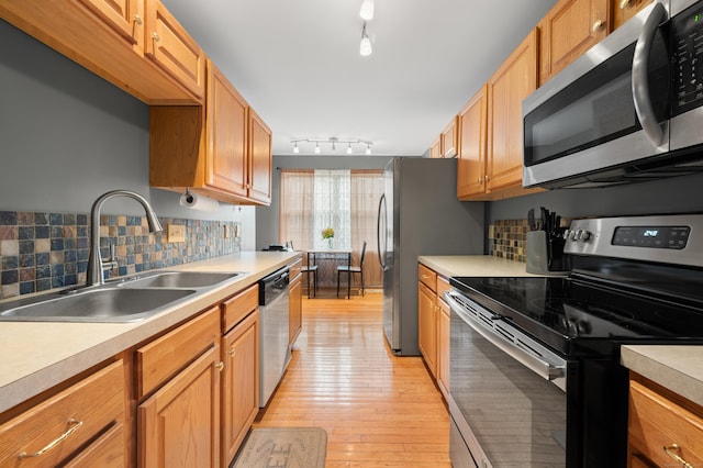 19 Hawthorne Dr Unit 124, New London, CT 06320 - kitchen featuring appliances with stainless steel finishes, a sink, light countertops, and light wood-style flooring