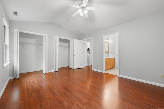 19 Hawthorne Dr Unit 124, New London, CT 06320 - unfurnished bedroom with multiple closets, vaulted ceiling, wood finished floors, baseboards, and ceiling fan