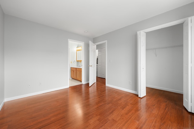 19 Hawthorne Dr Unit 124, New London, CT 06320 - unfurnished bedroom featuring a closet, wood finished floors, baseboards, and a spacious closet