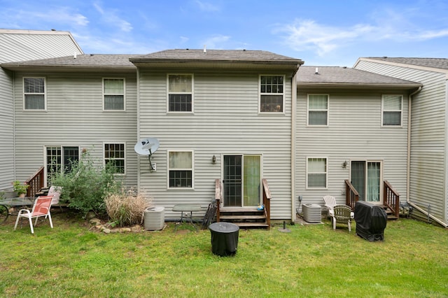 19 Hawthorne Dr Unit 124, New London, CT 06320 - rear view of house with entry steps, a yard, and central AC unit