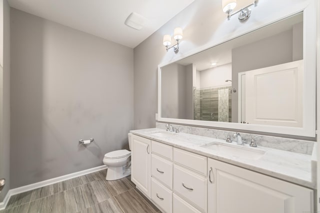 802 Center Meadow Ln Unit 802, Danbury, CT 06810 - bathroom with double vanity, toilet, a tile shower, and baseboards