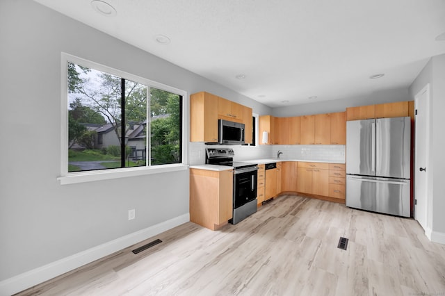 170 Heritage Vlg Unit B, Southbury, CT 06488 - kitchen with stainless steel appliances, light brown cabinets, baseboards, and light countertops