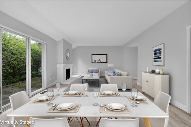 170 Heritage Vlg Unit B, Southbury, CT 06488 - dining space featuring light wood-style floors, a brick fireplace, and baseboards